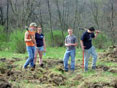Students prepare to plant trees.